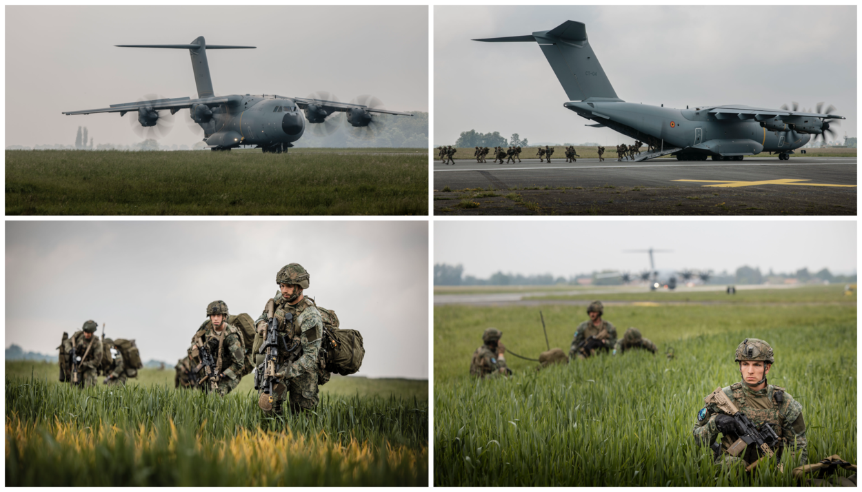 Militairen rennen uit de laadklep van een vliegtuig en wachten daarna tussen het hoge gras naast de landingsbaan.