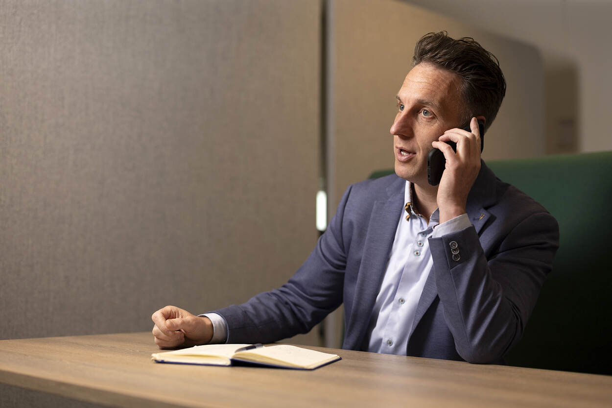 Wietse zit te bellen en maakt notities in een boekje.