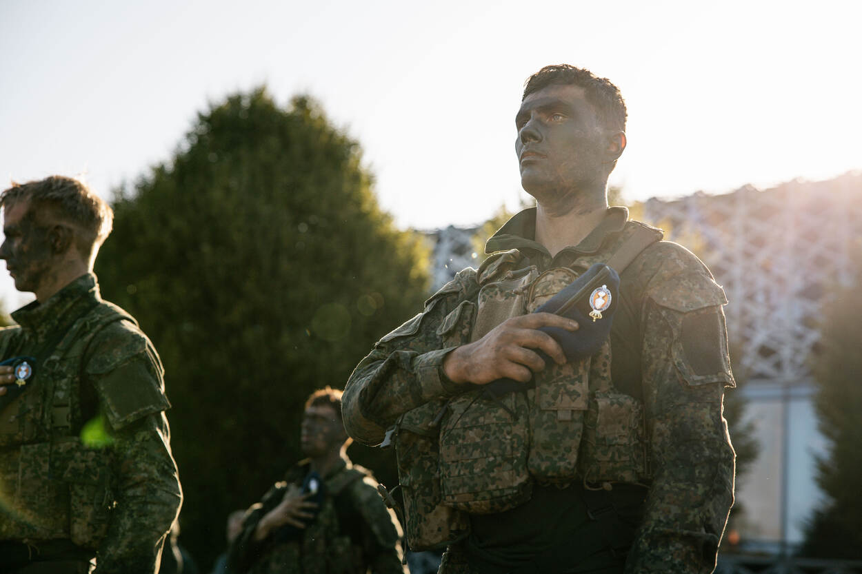 Student houdt de blauwe baret tegen de borst geklemd.