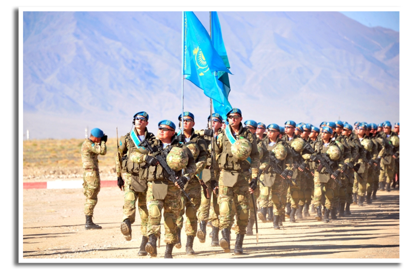 Kazachse militairen dragen de vlag van hun land binnen tijdens de openingsceremonie van een SCO-oefening.