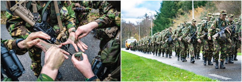 Grote groep marcherende militairen met zware bepakking en een wapen.