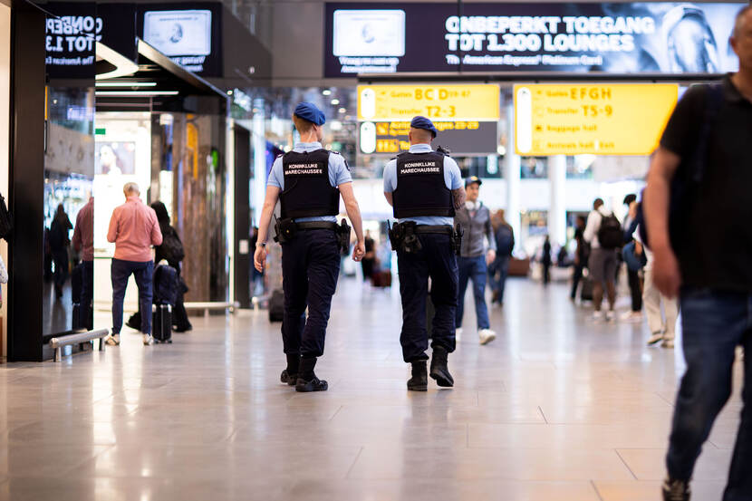 2 collega's lopen over Schiphol Plaza.