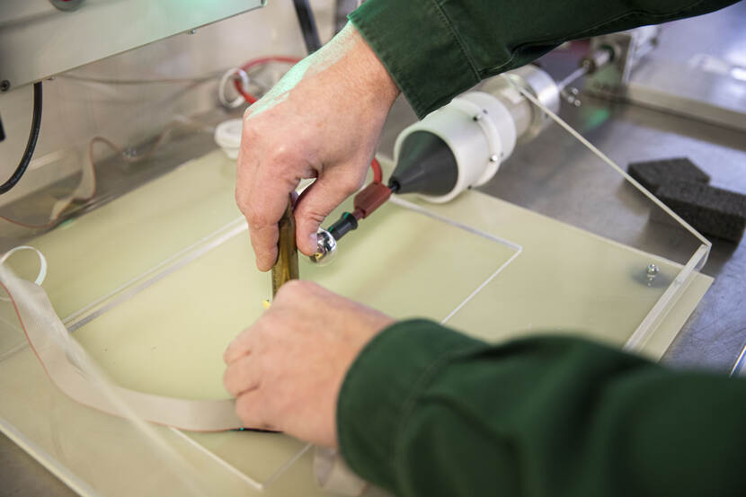 Een huls wordt door de mangel gehaald.