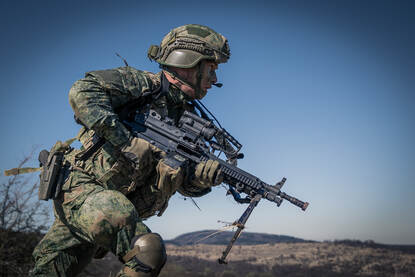 Een militair rent over het oefenterrein.